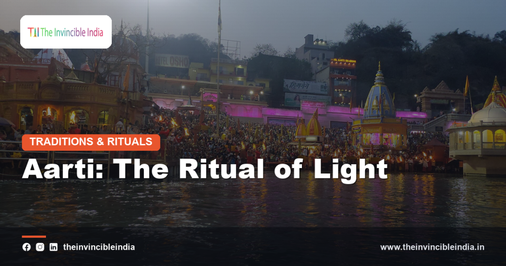 Priests performing aarti with lit lamps during evening temple worship