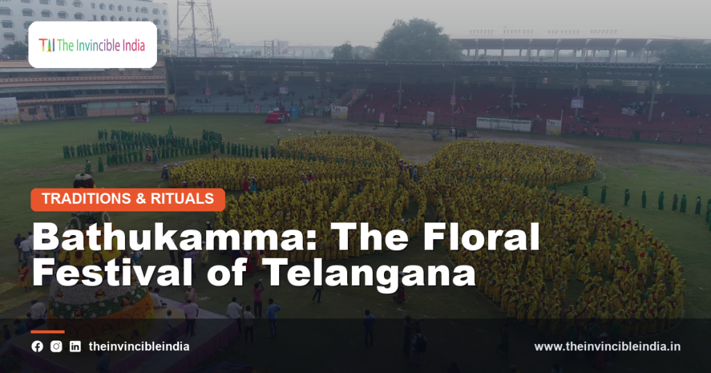 Women arranging colourful flowers into a layered Bathukamma during the Telangana festival